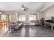 Open-concept living room features modern ceiling fan, neutral walls, and luxury vinyl flooring at 18750 E Ryan Rd, Queen Creek, AZ 85142