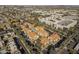 An aerial view shows a residential community with a pool, parking, and surrounding trees and city view at 1905 E University Dr # 219, Tempe, AZ 85288