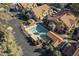 An aerial view of the condominium community featuring a pool and mature landscaping at 1905 E University Dr # 219, Tempe, AZ 85288