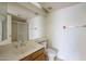 Bathroom featuring a large mirror, a vanity, a toilet, and a glass shower enclosure at 1905 E University Dr # 219, Tempe, AZ 85288