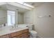 Bathroom featuring a large mirror, wood cabinets, and ample counter space at 1905 E University Dr # 219, Tempe, AZ 85288