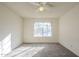 Spacious bedroom featuring a window for natural light, neutral walls, carpet, and a ceiling fan at 1905 E University Dr # 219, Tempe, AZ 85288