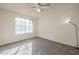 Bedroom featuring a window for natural light, neutral walls, carpet, and modern light fixture at 1905 E University Dr # 219, Tempe, AZ 85288