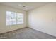 Bedroom featuring a large window for natural light, neutral walls, carpet, and closet at 1905 E University Dr # 219, Tempe, AZ 85288