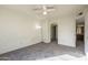 Bright bedroom featuring neutral walls, carpet, a ceiling fan, and an arched doorway at 1905 E University Dr # 219, Tempe, AZ 85288