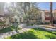 Beautifully landscaped community area with lush green grass and mature trees, creating a tranquil and inviting atmosphere at 1905 E University Dr # 219, Tempe, AZ 85288