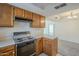 Galley kitchen features stainless steel oven and bright counter space at 1905 E University Dr # 219, Tempe, AZ 85288