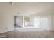 Airy living room filled with natural light, complemented by neutral tones and carpet, offering a blank canvas for personalization at 1905 E University Dr # 219, Tempe, AZ 85288