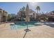 Exterior view of a pool with lounge chairs and shade umbrellas surrounded by palm trees and buildings at 1905 E University Dr # 219, Tempe, AZ 85288