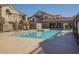 An eye-level shot of the community pool featuring lounge chairs and shade umbrellas at 1905 E University Dr # 219, Tempe, AZ 85288