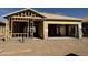 Framing of new home with unfinished garage and entry showing layout and design against a blue sky at 2076 E Bucking Bronco Dr, San Tan Valley, AZ 85140