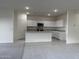 Open-concept living space with a kitchen view, carpeted living room area, and gray tile at 2076 E Bucking Bronco Dr, San Tan Valley, AZ 85140