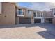 Townhome exterior featuring garages, balconies, and a paved driveway at 2121 W Sonoran Desert Dr # 41, Phoenix, AZ 85085