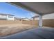 View of a large backyard with block wall and covered patio at 21250 E Sparrow Dr, Queen Creek, AZ 85142