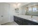 Bathroom with double sink vanity with modern fixtures and a glass shower at 21250 E Sparrow Dr, Queen Creek, AZ 85142