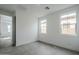 Bright bedroom featuring tile floor, two windows, and neutral walls at 21250 E Sparrow Dr, Queen Creek, AZ 85142