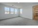 Bright bedroom featuring neutral carpet, white walls, and several windows, creating an inviting space at 21250 E Sparrow Dr, Queen Creek, AZ 85142