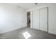 Bedroom with sliding closet doors, neutral walls and floors leading into a hallway at 21250 E Sparrow Dr, Queen Creek, AZ 85142