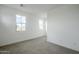 A well-lit bedroom featuring neutral carpet, white walls, and lots of natural light at 21250 E Sparrow Dr, Queen Creek, AZ 85142