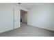 Bright bedroom with neutral walls and floors leading into a hallway at 21250 E Sparrow Dr, Queen Creek, AZ 85142