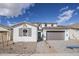 Charming two-story home featuring a symmetrical facade, a two car garage and desert landscaping at 21250 E Sparrow Dr, Queen Creek, AZ 85142