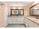 Bathroom featuring a double granite vanity, framed mirrors, and ample storage at 2331 E Evans Dr, Phoenix, AZ 85022