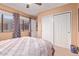 Bedroom featuring a large window with curtains, a ceiling fan and closet creating a serene space at 2331 E Evans Dr, Phoenix, AZ 85022