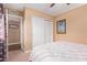 This bedroom features neutral walls and a white closet door, creating a calming and organized space at 2331 E Evans Dr, Phoenix, AZ 85022