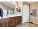 Bathroom features dual sinks, modern fixtures, tile floor and ample cabinet space at 24204 N 27Th Pl, Phoenix, AZ 85024