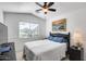 Bright bedroom with large window, ceiling fan, and neutral décor at 24204 N 27Th Pl, Phoenix, AZ 85024