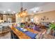 Open-concept dining area with a large table, seamlessly connecting to the kitchen and living room at 24204 N 27Th Pl, Phoenix, AZ 85024