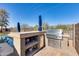 Outdoor kitchen features a built-in BBQ, granite counter top, and stainless steel drawers at 24204 N 27Th Pl, Phoenix, AZ 85024