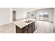 Spacious kitchen island featuring granite countertops and a stainless steel sink at 25179 W Atlanta Ave, Buckeye, AZ 85326