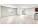 Bright living room with neutral walls, tile flooring, and sliding glass doors to the backyard at 25179 W Atlanta Ave, Buckeye, AZ 85326