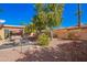 Beautiful desert backyard featuring mature landscaping, patio, and a charming garden area at 26401 S Brentwood Dr, Sun Lakes, AZ 85248