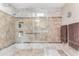 Large walk-in shower featuring beautiful neutral tile work, a rain shower head, and a built-in bench at 26401 S Brentwood Dr, Sun Lakes, AZ 85248