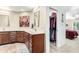 Bright bathroom featuring double sinks, a linen cabinet, and a separate room with a closet and toilet at 26401 S Brentwood Dr, Sun Lakes, AZ 85248