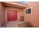 Inviting front entrance with a red double door, small window, bench, and desert landscaping in front at 26401 S Brentwood Dr, Sun Lakes, AZ 85248