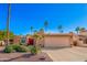 Charming single-story home featuring a spacious two car garage, mature landscaping, and a red double door entrance at 26401 S Brentwood Dr, Sun Lakes, AZ 85248