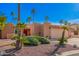 Charming single-story home featuring a spacious two car garage, mature landscaping, and a red double door entrance at 26401 S Brentwood Dr, Sun Lakes, AZ 85248