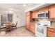 Well-lit kitchen features tile backsplash, granite countertops, and a breakfast nook at 26401 S Brentwood Dr, Sun Lakes, AZ 85248