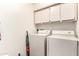 Bright laundry room featuring a washer, dryer, and extra storage space at 26401 S Brentwood Dr, Sun Lakes, AZ 85248