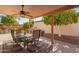 A cozy covered patio with plenty of shade and an outdoor dining area at 26401 S Brentwood Dr, Sun Lakes, AZ 85248