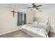 Bright bedroom featuring a tufted headboard, neutral walls, and carpeted floors at 2812 W Heatherbrae Dr, Phoenix, AZ 85017