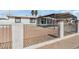 Front yard featuring a gravel area, metal fence, and mature palm trees at 2812 W Heatherbrae Dr, Phoenix, AZ 85017