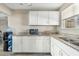 Well-lit kitchen showcasing granite countertops, white cabinets, and modern appliances for a functional cooking space at 2812 W Heatherbrae Dr, Phoenix, AZ 85017