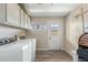 Spacious laundry room featuring updated flooring and a practical layout, offering convenience and functionality at 2812 W Heatherbrae Dr, Phoenix, AZ 85017