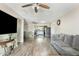 Open-concept living space with wood-look flooring, ceiling fans, and seamless connection to the dining and kitchen areas at 2812 W Heatherbrae Dr, Phoenix, AZ 85017