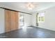 Bedroom featuring tiled floors, a ceiling fan, and a large sliding barn door at 3027 N 21St Pl, Phoenix, AZ 85016