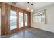 Open living room featuring a ceiling fan, wood walls, and views of the patio at 3027 N 21St Pl, Phoenix, AZ 85016